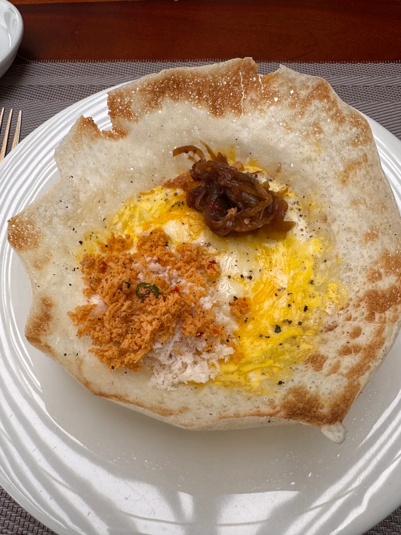 A Sri Lankan hopper on a plate, crispy edges and soft centre