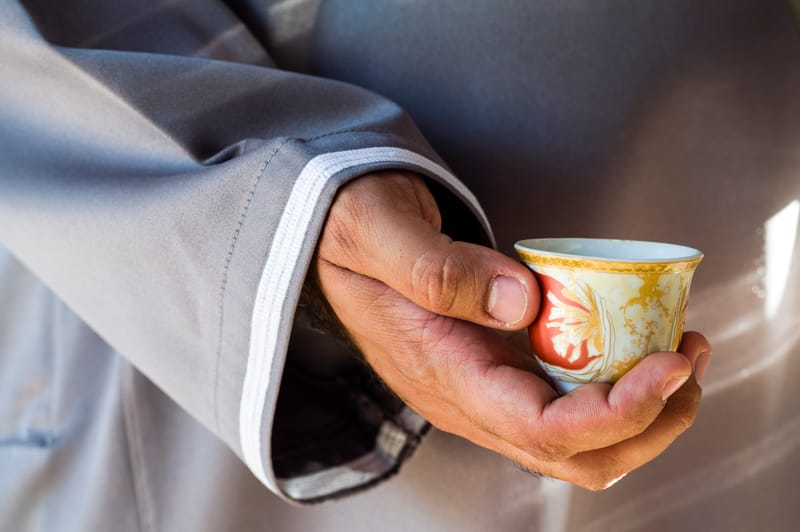 Gahwa poured from a dallah into small finjans, a ritual of welcome unchanged for centuries.