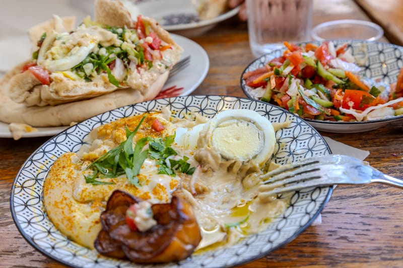 A table filled with traditional Middle Eastern dishes in Tel Aviv