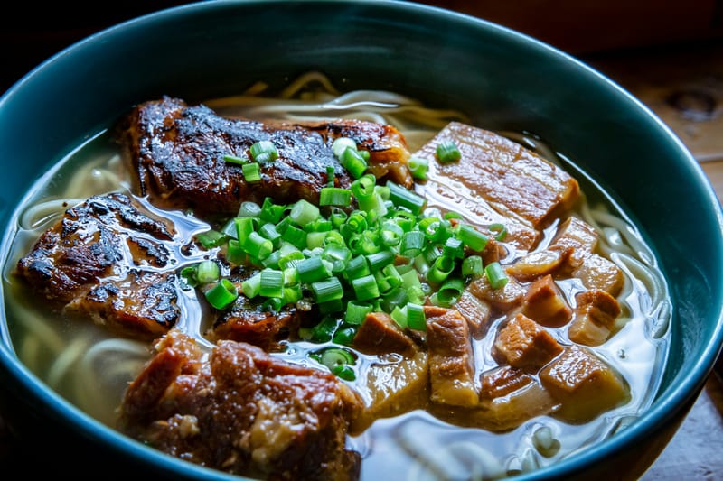 Okinawa soba, thick wheat noodles in a clear pork-bone broth topped with slow-stewed ribs.