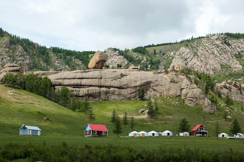 A Terelj tourist ger camp tucked below granite cliffs. Is Mongolia cheap to travel? It depends on where you stay