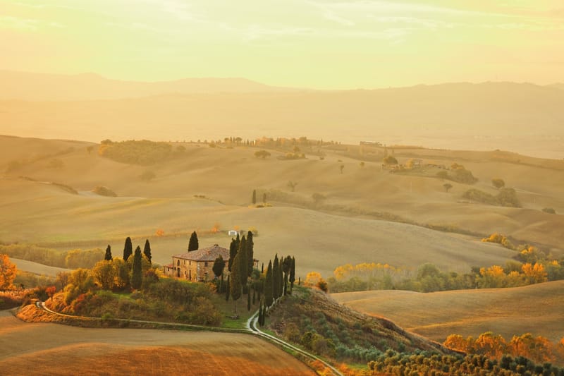 The Val d'Orcia in Tuscany comes alive with poppies and wildflowers each April, framed by cypress-lined roads and hilltop villages.
