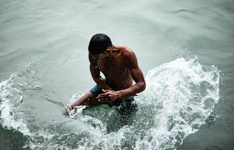 A man bathing in the Ganges River in Varanasi.