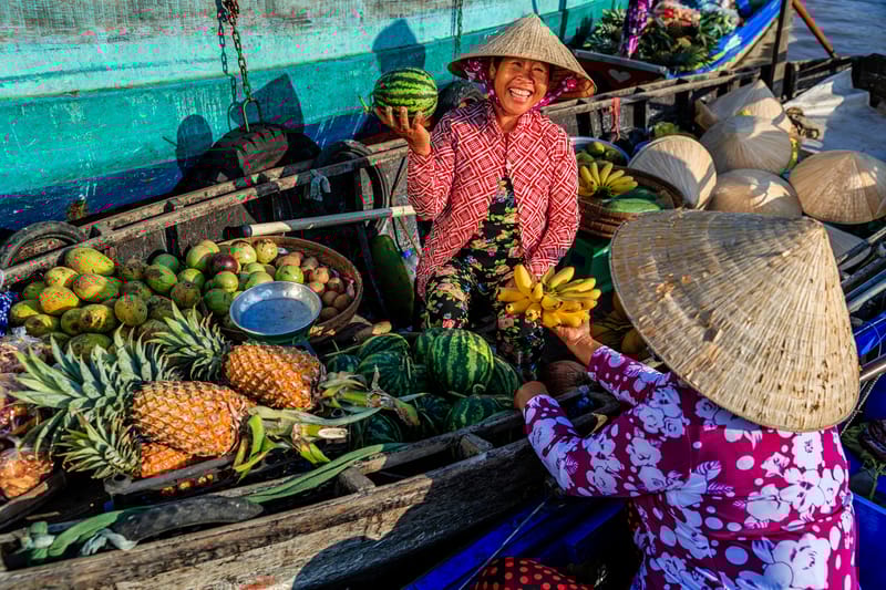 Early morning scene at a Mekong Delta floating market, where river life and agriculture meet.