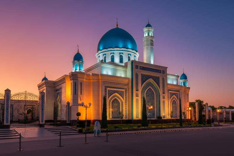 Twilight Illuminates the Islam Ata Mosque, Highlighting Its Blue Dome, Minarets, and Intricate Tilework