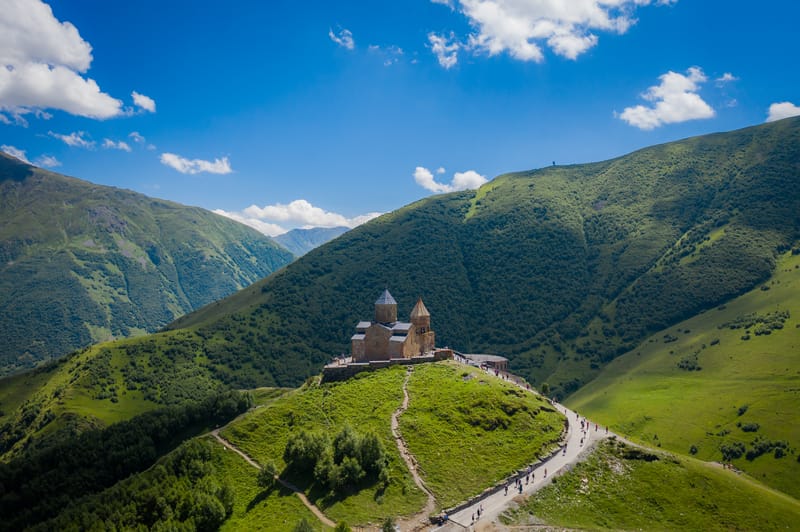 The 14th-century Gergeti Trinity Church in the majestic Caucasus Mountains and Mt. Kazbek in Georgia