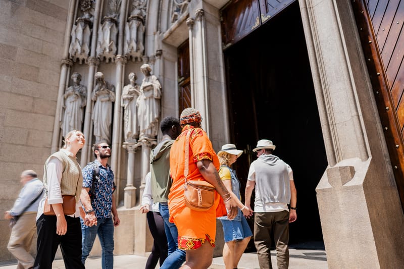 A faith group arrives together at a grand cathedral entrance, one of many sacred sites that can be woven into a Tailormade religious tour itinerary.